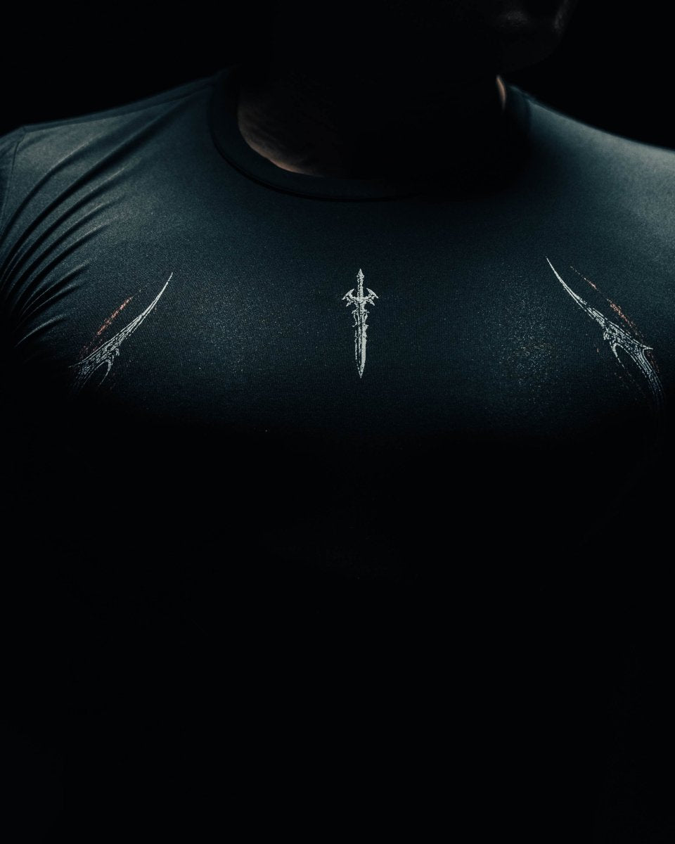 Dark t-shirt with white embroidered designs on a black background