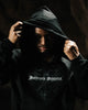 Person wearing a black hoodie with 'Intrepid Athletic' text, holding the hood over their head.