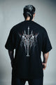 Person wearing a black t-shirt with a white graphic design on the back, standing against a plain background.