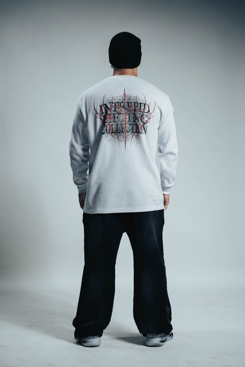 Person wearing a white long-sleeve shirt with a graphic design on the back against a gray background