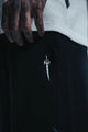 Black jacket with a white embroidered design on a dark background