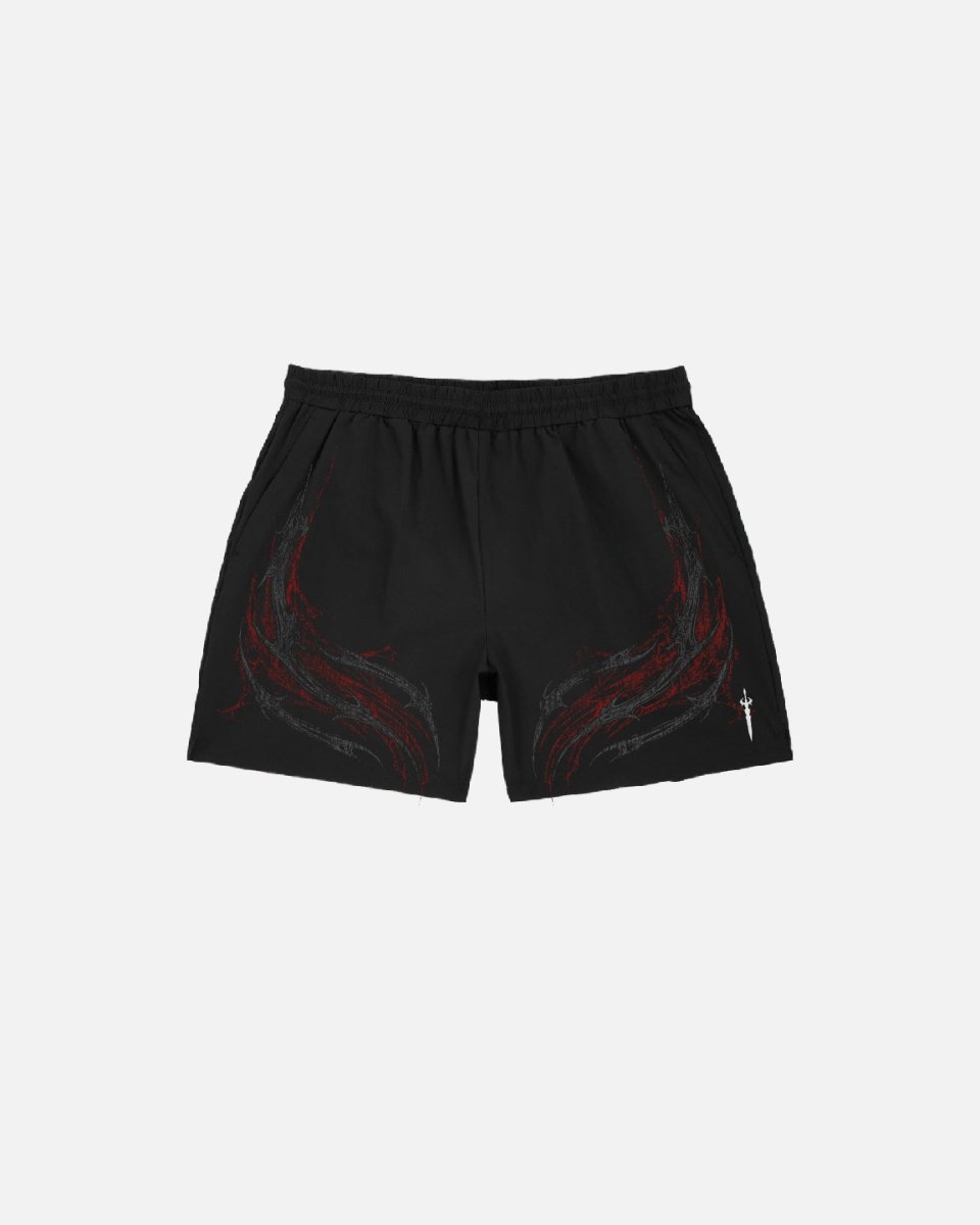 Black shorts with red designs on a light gray background