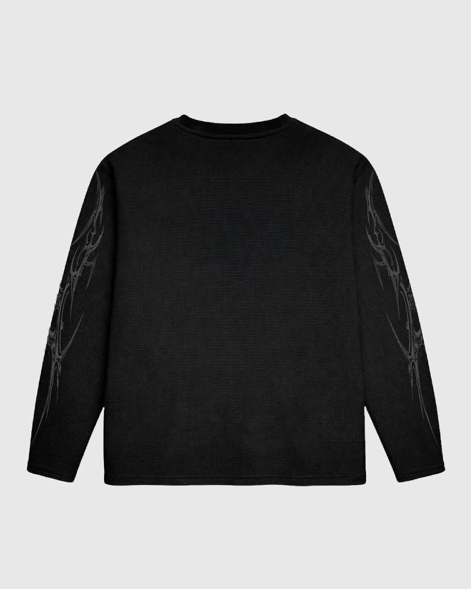 Black long-sleeve shirt with abstract designs on sleeves against a light gray background