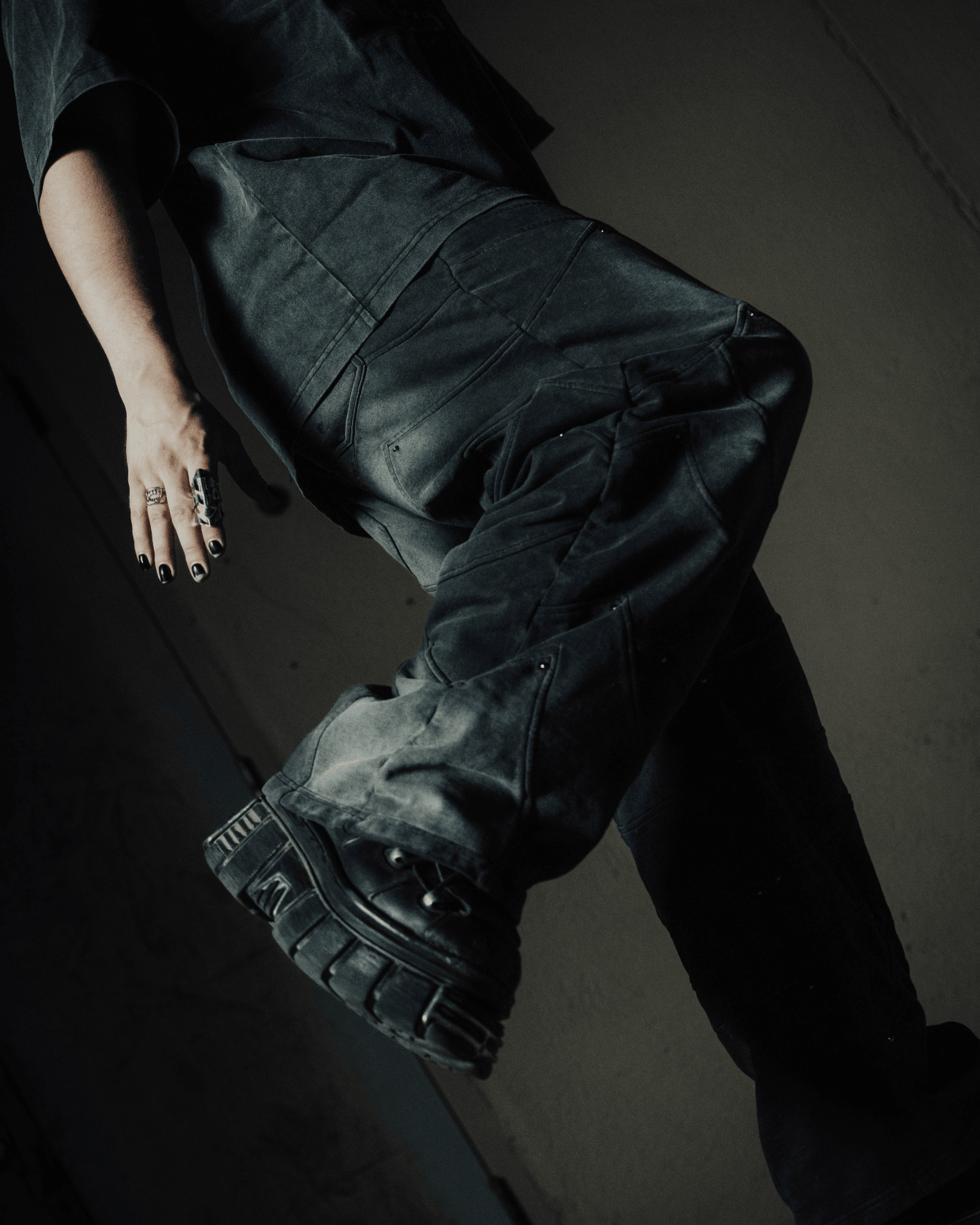 Person wearing dark pants and shoes on a plain background