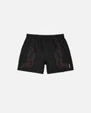Black shorts with red tribal designs on a white background