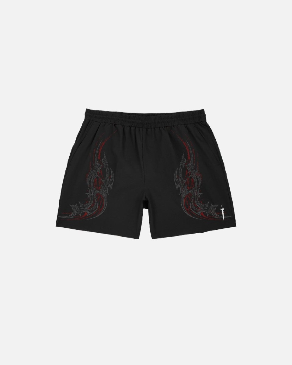 Black shorts with red tribal designs on a white background