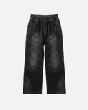 Black leather pants with geometric patterns on a white background