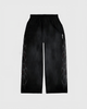 Black pants with geometric patterns on a light gray background
