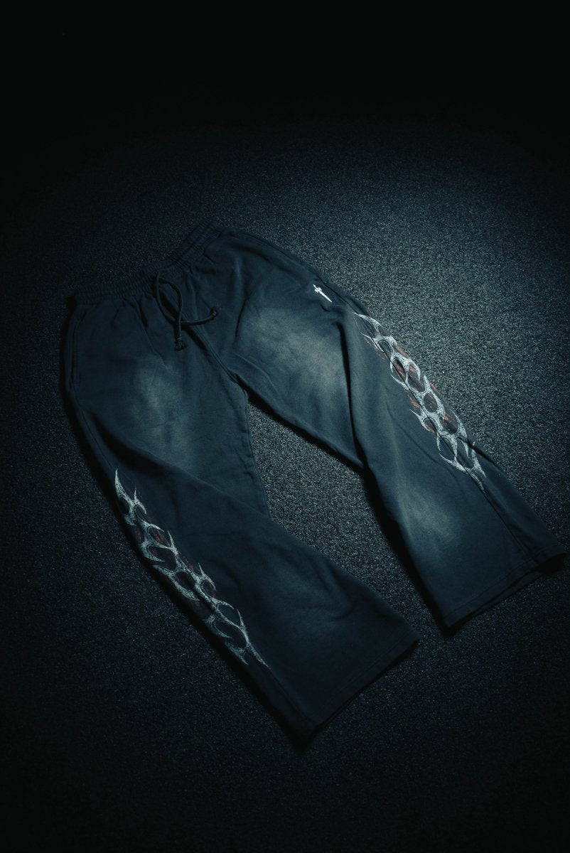 Dark fabric with white lace detailing on a textured dark surface