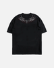 Black t-shirt with a unique design on a light gray background